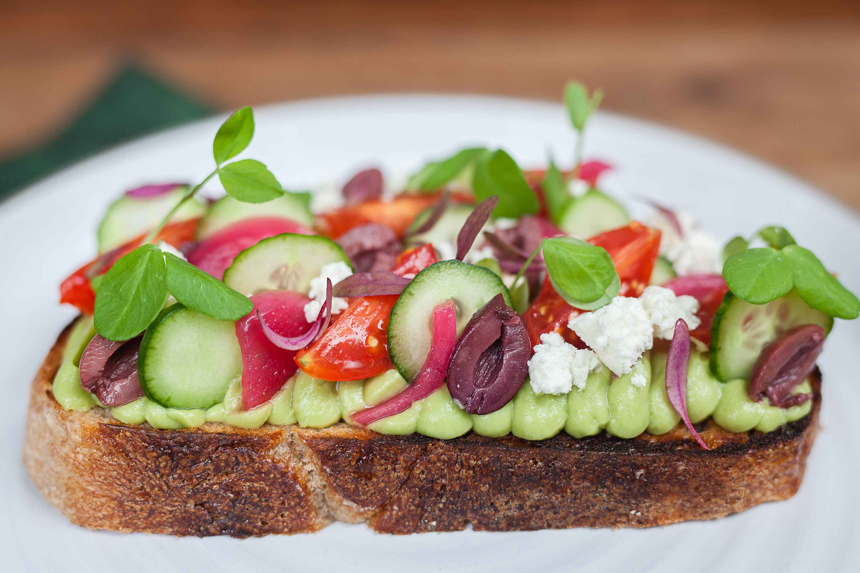 salad toast with cucumber olives tomatoes and some other ingredients